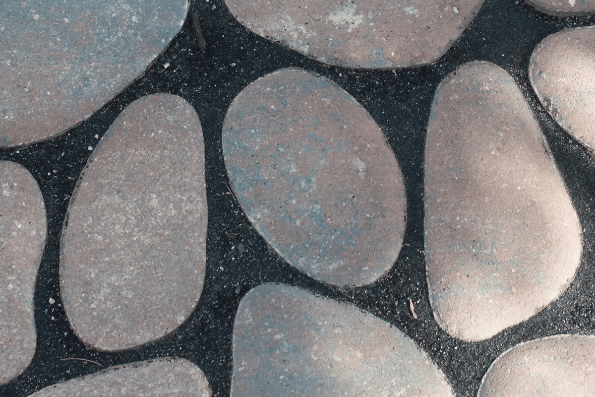 Round organic shaped concrete pavers with black filling between for the Environmental Paver Collection