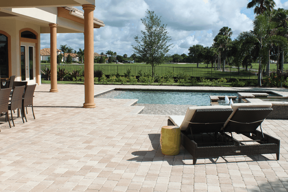 A pool deck of pavers in a client's backyard